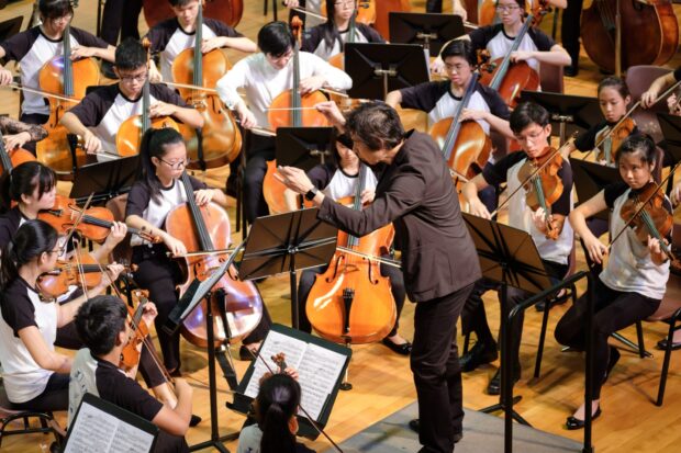 Principal Conductor Joshua Tan leds the youth orchestra
