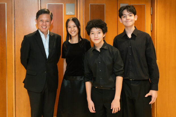 Minister Chan with members of the SNYO, comprising (L-R) Claudia Toh, Bass Clarinet; Keith Ong, Concertmaster, Violin; Justin Damhaut, Flute.