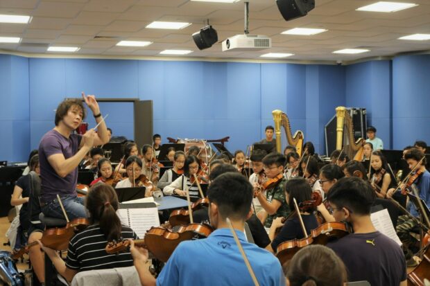 Practising the repertoire with Principal Conductor Joshua Tan at the SNYO Studios