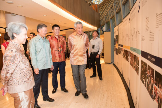 SSG CEO Chng Hak-Peng and Chairman Mr Goh Yew Lin walk PM Lee and Mrs Lee through a timeline of the SSO's 40-year history.