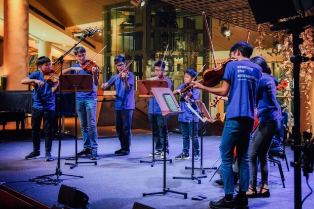 SNYO members performing at the Esplanade Concourse in 2024 as part of the March On series.