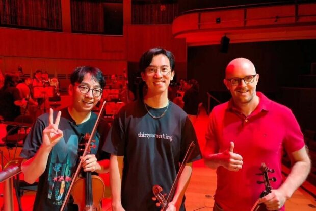 Andrew with TwoSet Violin’s Brett and Eddy during a rehearsal for Sacrilegious Games in July 2026.