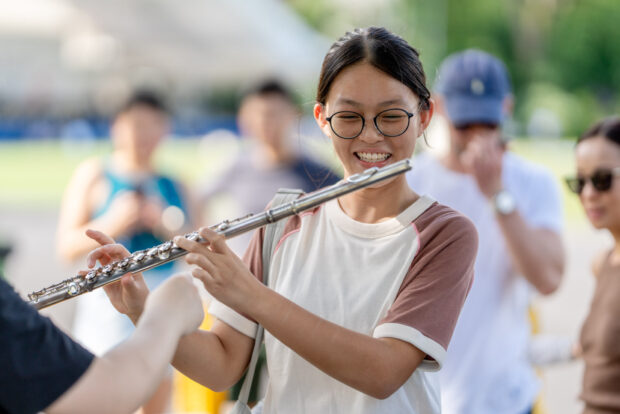 Attendees trying out various instruments at the Instrument Petting Zoo.