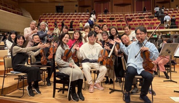 SSO violinist Kong Xianlong (centre) with the TMSO first violin section in Tokyo (February 2026).