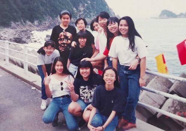 Having fun staying together by a fishing village during the tour